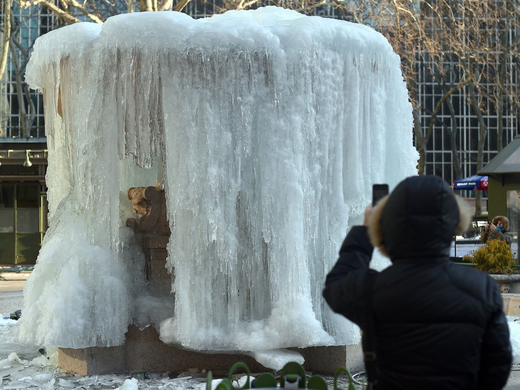 The Josephine Shaw Lowell Fountain in Bryant Park is frozen. Photograph: Timothy A. Clary/AFP/Getty Images